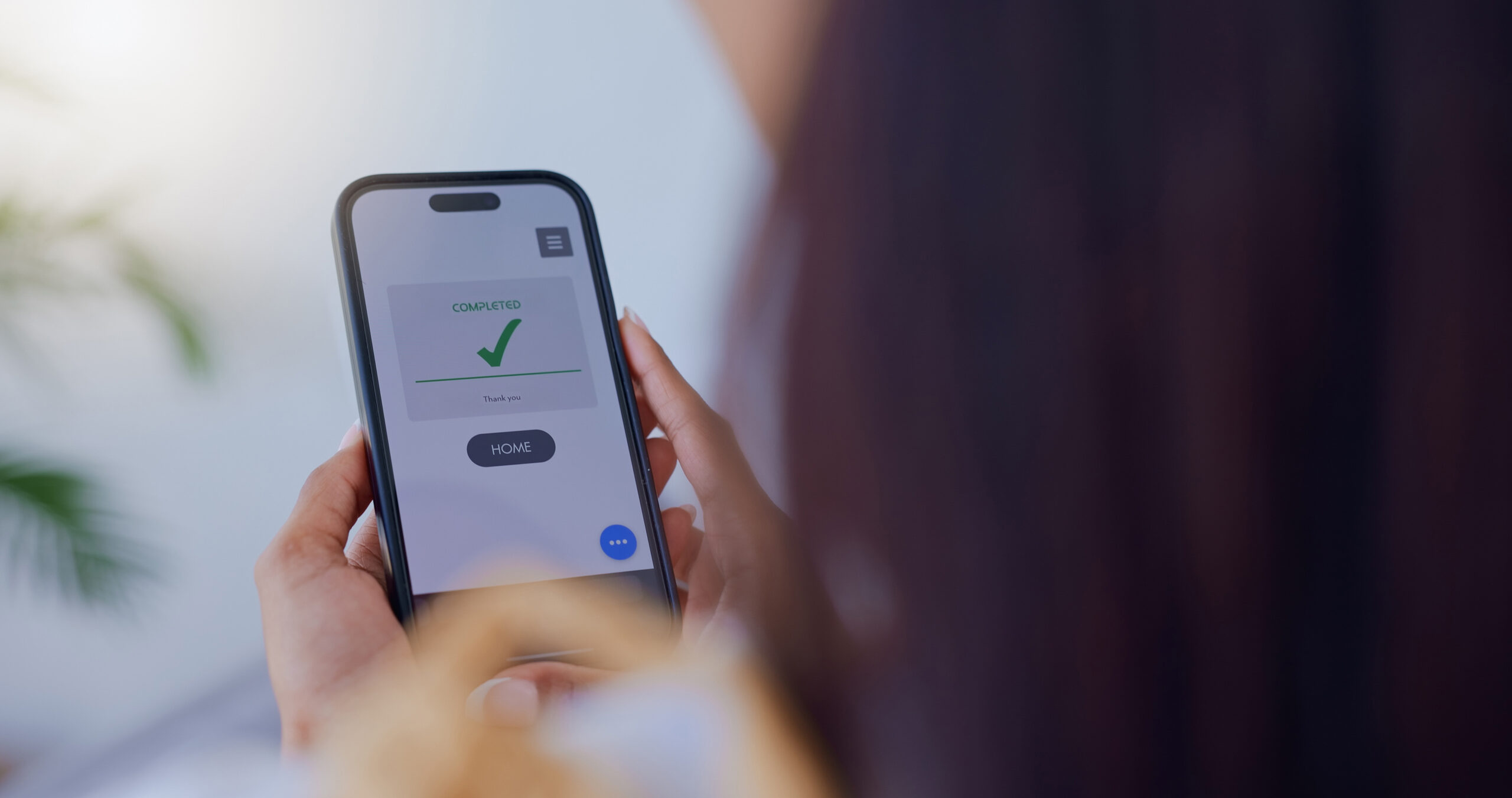 Woman completing a form on her phone.